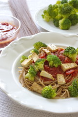 spaghetti served with broccoli, tofu and tomato sauce