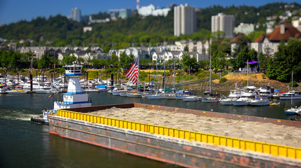 Tugboat Pushes a Barge Down the Willamette River in Portland, Or