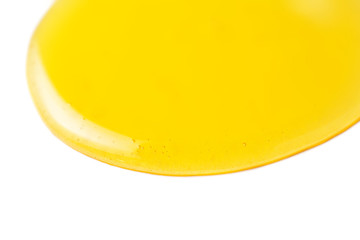 Honey flowing on a white background macro