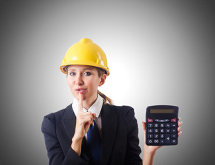 Female construction worker with calculator