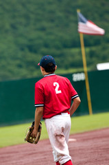 Teen baseball player with American Flag