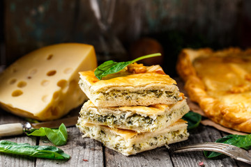 Homemade pie stuffed with cheese and spinach