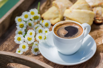 Delicious croissant and coffee in garden