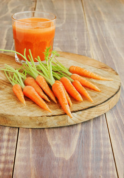 fresh carrots on a wooden board