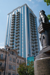 Obraz premium Statue with modern skyscrapers on background, Kyiv, Ukraine