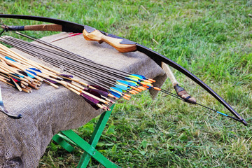 Bow and arrows on small table.