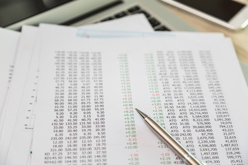 Financial charts on the table with laptop