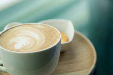 Hot latte art coffee on table ( Filtered image processed vintage