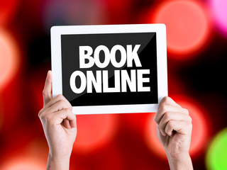 Tablet pc with text Book Online with bokeh background