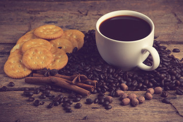 Cup of coffee on a wooden board and biscuits