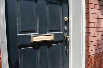 Brass mail slot on door