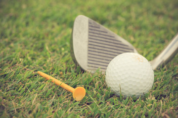 Golf club and ball in grass vintage color