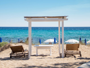Sea Coastline with wooden gazebo and Beach Beds