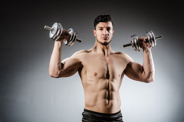 Plakat Muscular ripped bodybuilder with dumbbells