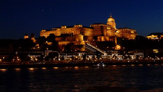 Royal Palace or Buda Castle at evening, Budapest in Hungary. With night illumination reflected in Danube river.