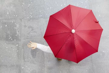 Fotobehang Man holding a red umbrella outdoors © cristovao31