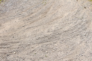 Bicycle tracks on a road with stone chips