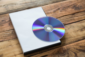 Blank compact disc with cover on wood background ground