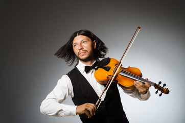 Fototapeta premium Man playing violin in musical concept