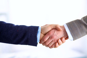 Closeup of a business handshake, on white background