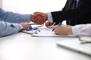 Closeup of a business handshake, on white background