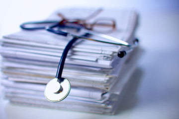 Medical stethoscope on the stack of paper