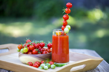 Cherry tomatoes and a glass of tomato juice.