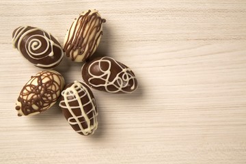 Chocolate Easter Eggs Over Wooden Background