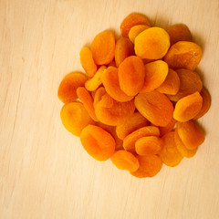 Healthy diet. Dried apricots set on wooden table.