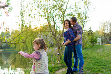 family dad mother and daughter on a walk on nature