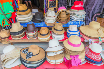 Colorful summer hats lie for sale
