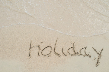 holiday, word drawn on the beach