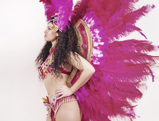 Brazilian samba dancer wearing traditional pink costume profile