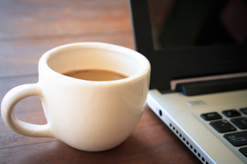 coffee cup put on laptop