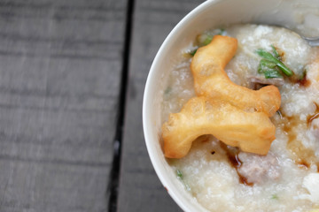 close-up rice gruel and deep-fried doughstick on wood background