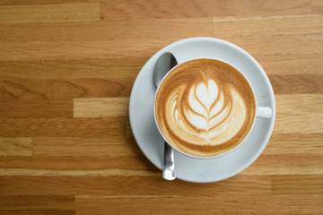 A cup of coffee with leaves pattern