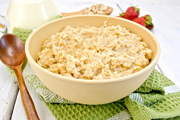 Oatmeal in bowl on light board