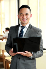 businessman holding a laptop