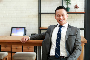 businessman look relax sitting and smiling at coffee shop