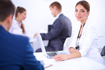 Fototapeta premium Beautiful young business people with colleagues discussing in