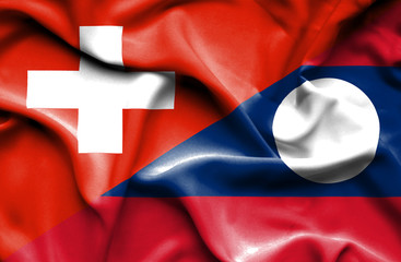 Waving flag of Laos and Switzerland