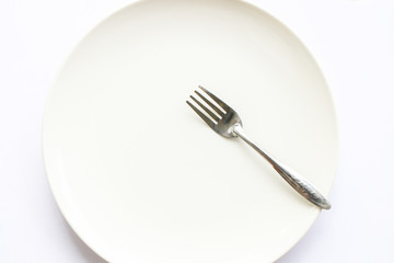 white empty dish with fork on white background