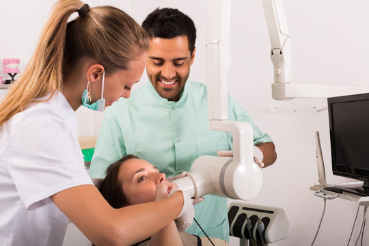 Dentist examines patient at clinic