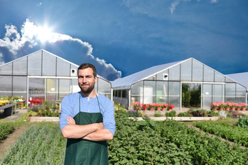 Portrait erfolgreicher Gärtner/ Bauer - im hintergrund Gewächshaus und Gemüsefeld // successful...