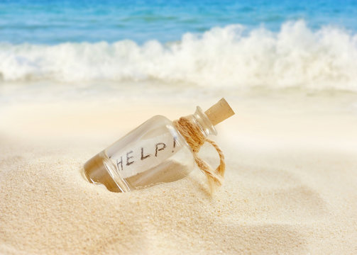 Bottle with a message on sand beach