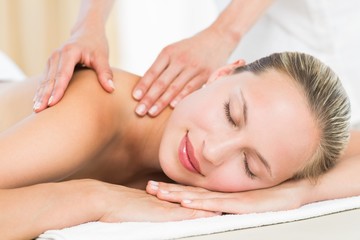 Obraz na płótnie Canvas Pretty blonde enjoying a massage at the health spa