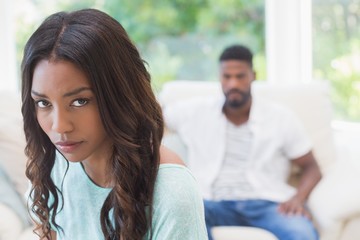 Couple not talking after a dispute on the sofa