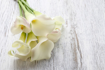 Towels and bouquet of white calla flowers - obrazy, fototapety, plakaty