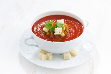 fresh gazpacho with croutons in a white bowl