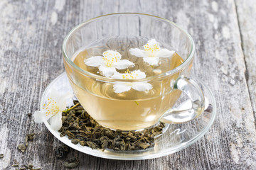 green tea with jasmin on wooden table
